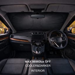 A car interior featuring a black reflective sunshade across the windshield, with leather seats and wooden accents.