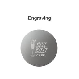 A round metal coaster with a brushed silver finish and a logo engraved on it.