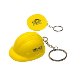 A yellow keyring featuring a helmet-shaped stress reliever and a round keychain, both with logos.