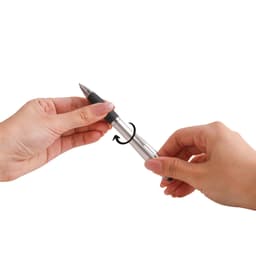 A silver stylus pen with a black grip is being held between two hands, demonstrating its features.