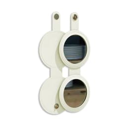 A round folding pocket mirror in cream, featuring two circular mirrors with a leather-like finish and a button closure.