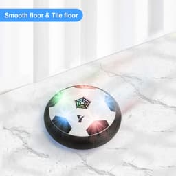 A hover soccer ball with a black rim and a white surface featuring a soccer design, glowing with multicoloured lights.