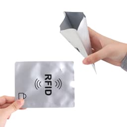 A silver RFID passport holder being held, with a hand displaying a matching RFID card.