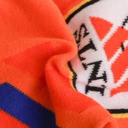An orange elastic spandex scarf featuring a patterned design in contrasting colours with a logo.
