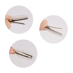 An oval iridescent alligator hair clip, showcasing its shiny surface and clip mechanism, held between fingers.