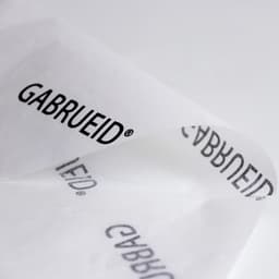 A sheet of white Kraft paper featuring a repeating black logo in an elegant font.