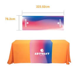 A large table runner featuring a gradient of pink and blue colours with an orange tablecloth underneath. It includes a logo.