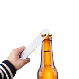 A drink bottle opener in hand, featuring a sleek design, used to lift the cap off a brown beer bottle.
