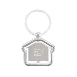 A silver metal keyring in the shape of a house, with a circular keyring attachment.