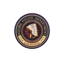 A circular patch featuring a profile of a Native American chief, with text around it indicating the Houma Police Department, Louisiana.