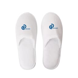 White hotel slippers featuring a logo on each slipper. The slippers have a soft, plush design.