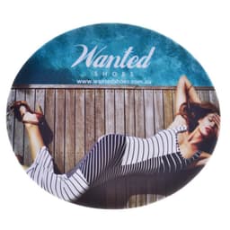 A round mouse mat featuring a woman in a striped dress lying on a wooden surface, with a logo at the top.