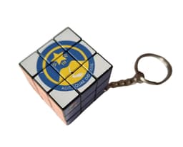 A Rubik's Cube keyring featuring coloured squares and a logo, displayed on a white background.