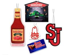 A collection of air fresheners in various shapes, including a ketchup bottle, a logo, and promotional tags in red and white.