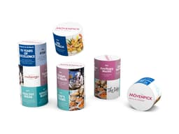 Various cylindrical promotional containers in vibrant colours, featuring images of food and a logo on each.