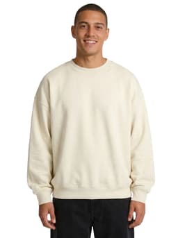 A model wearing a cream-coloured oversized crew neck fleece sweatshirt. The product is available in 4XL and 5XL sizes.