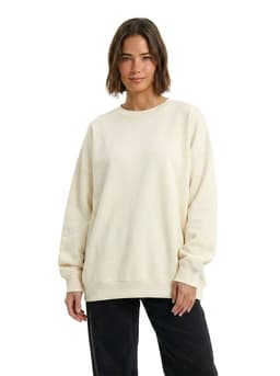 An oversized cream fleece crew neck sweatshirt displayed on a model, featuring long sleeves and a relaxed fit.