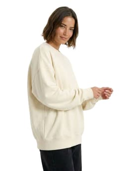 An oversize cream fleece crew neck sweatshirt with long sleeves, featuring a relaxed fit.