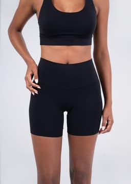 High rise legging shorts in black, featuring a smooth waistband and a fitted design. Includes a logo.