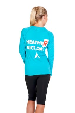 A long-sleeve women's t-shirt in heather blue with a logo on the back, paired with black leggings.