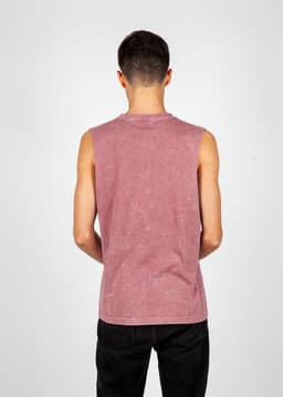 A men's stone wash tank in a pink hue, featuring a sleeveless design and a branding logo on the back.