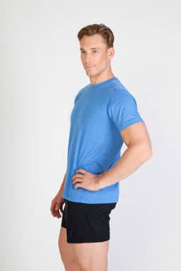 A blue heather T-shirt displayed on a model, styled with black shorts. The shirt features a logo.