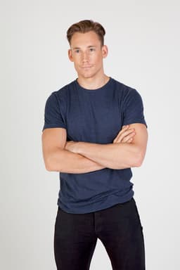 A navy blue marl crew neck t-shirt displayed on a model with arms crossed, featuring a subtle logo.