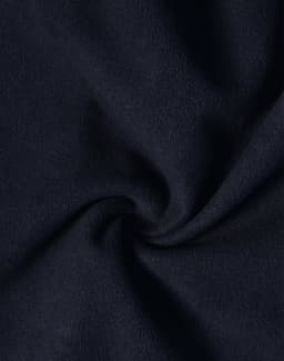 A close-up view of dark navy softshell fabric, featuring a smooth texture with a slight sheen.