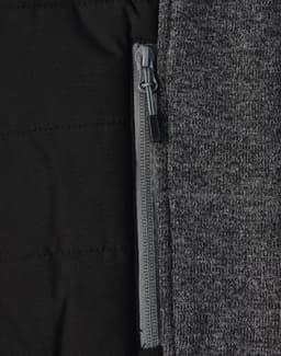 A grey heather fabric with a quilted black interior and a zippered pocket detail. The jacket has a sleek design.