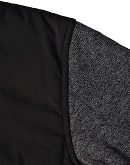 A black quilted jacket featuring a heather grey sleeve. Includes a logo on the fabric.
