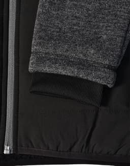 A black quilted jacket featuring heather grey sleeves and a ribbed cuff, with a side zipper and fabric texture detail.