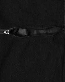 A black Long Line Stadium Jacket featuring a zippered pocket and a smooth lining. The jacket has a branding logo.