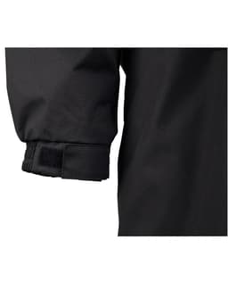 A close-up of the cuff of a black Long Line Stadium Jacket featuring adjustable fastenings.