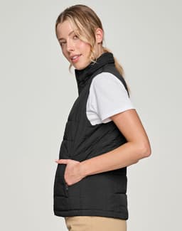A black insulated puffer vest with a 3D cut, featuring a zip pocket and a sleek design.