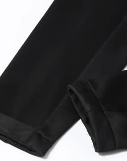 A black sustainable softshell corporate jacket featuring sleek, smooth fabric and a stylish design.