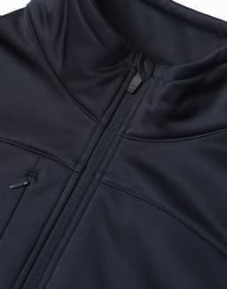 A black sustainable softshell jacket featuring a zip closure and a high collar, with an attached logo.