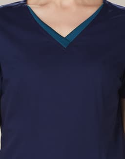 A navy scrub top featuring a contrasting teal V-neck collar and short sleeves. It has a logo on the front.