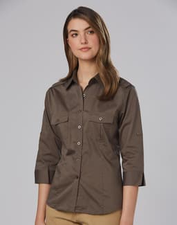 A women's military-style shirt in khaki with 3/4 sleeves and two front pockets, featuring a logo on the fabric.