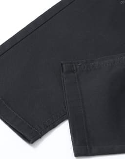 A close-up of men's black flexi chino pants, highlighting the fabric and stitching details.