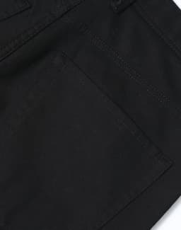 Black flexi chino pants featuring a classic jean style with visible stitching and pockets. Includes a logo.