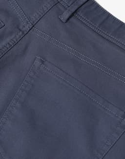 Men's flexi chino pants in grey featuring detailed stitching and a back pocket design. Includes branding on the waistband.