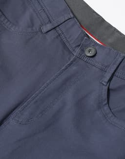 A pair of men's flexi chino pants in navy, featuring a button closure and pockets, with branding visible.