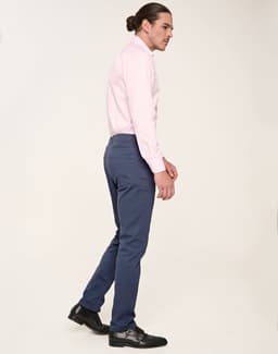 Men's flexi chino pants in navy, styled with a light pink shirt and black shoes, featuring a sleek fit.