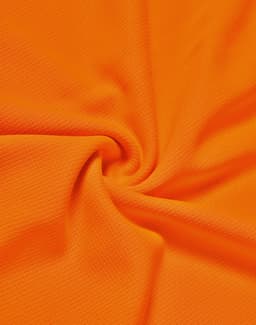An orange fabric showcasing a textured pattern, suitable for polo shirts. The material appears lightweight and breathable.