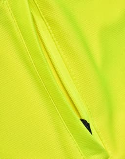 A close-up of a bright yellow polo shirt featuring a zipped pocket and a subtle logo.