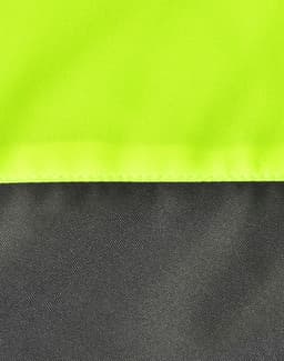 A close-up of a hi-vis quilted safety jacket featuring fluorescent yellow and dark grey sections, plus visible stitching.