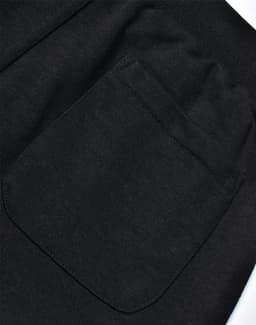 A close-up view of a black poly/cotton terry sweat pant, highlighting a back pocket detail.
