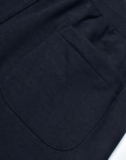 A dark grey pair of poly/cotton terry sweat pants featuring a back pocket. The fabric is soft and textured.
