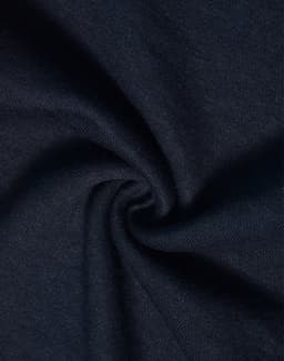 A close-up of dark navy fabric with a smooth, soft texture, showcasing a poly/cotton blend.