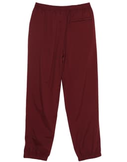 Burgundy track pants with an elastic waistband and cuffs, featuring a logo on the side.